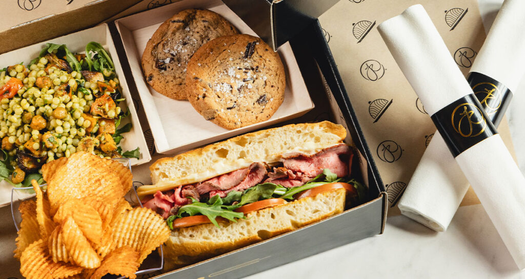 catering boxed lunch including sandwich and cookies
