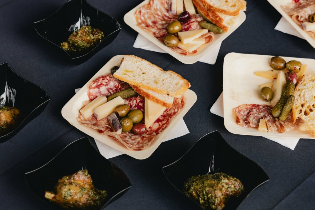 plates of cheese, olives, bread, and meat